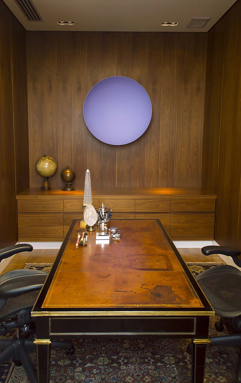 Wood-panelled office with contemporary artwork